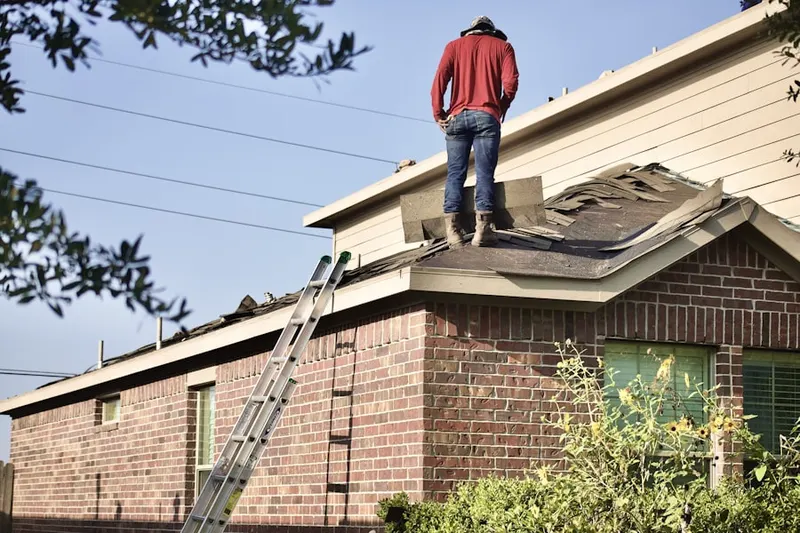 Professional roofer working on a residential roof in Itasca